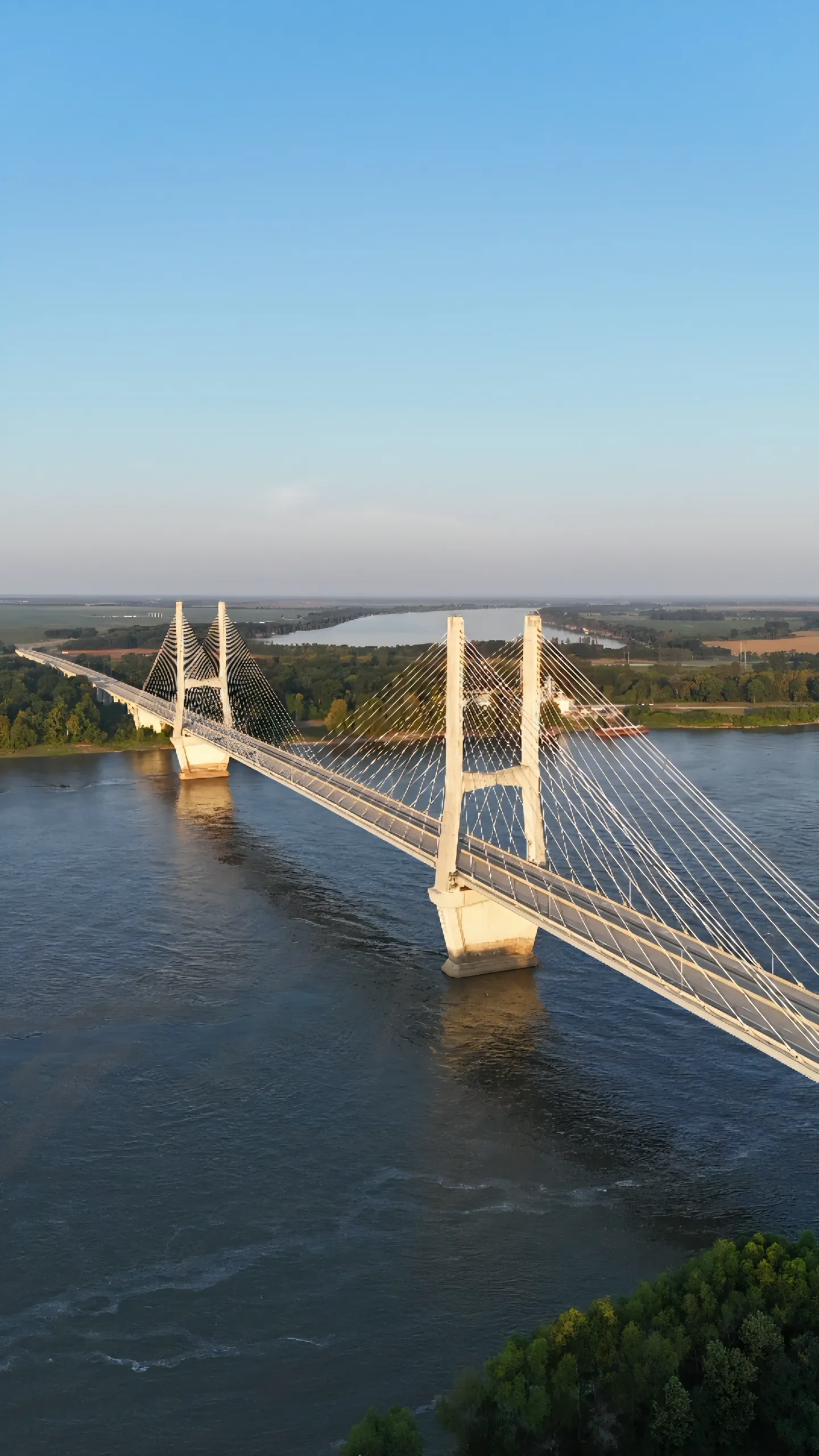 Golden-hour aerial view of a bridge over water